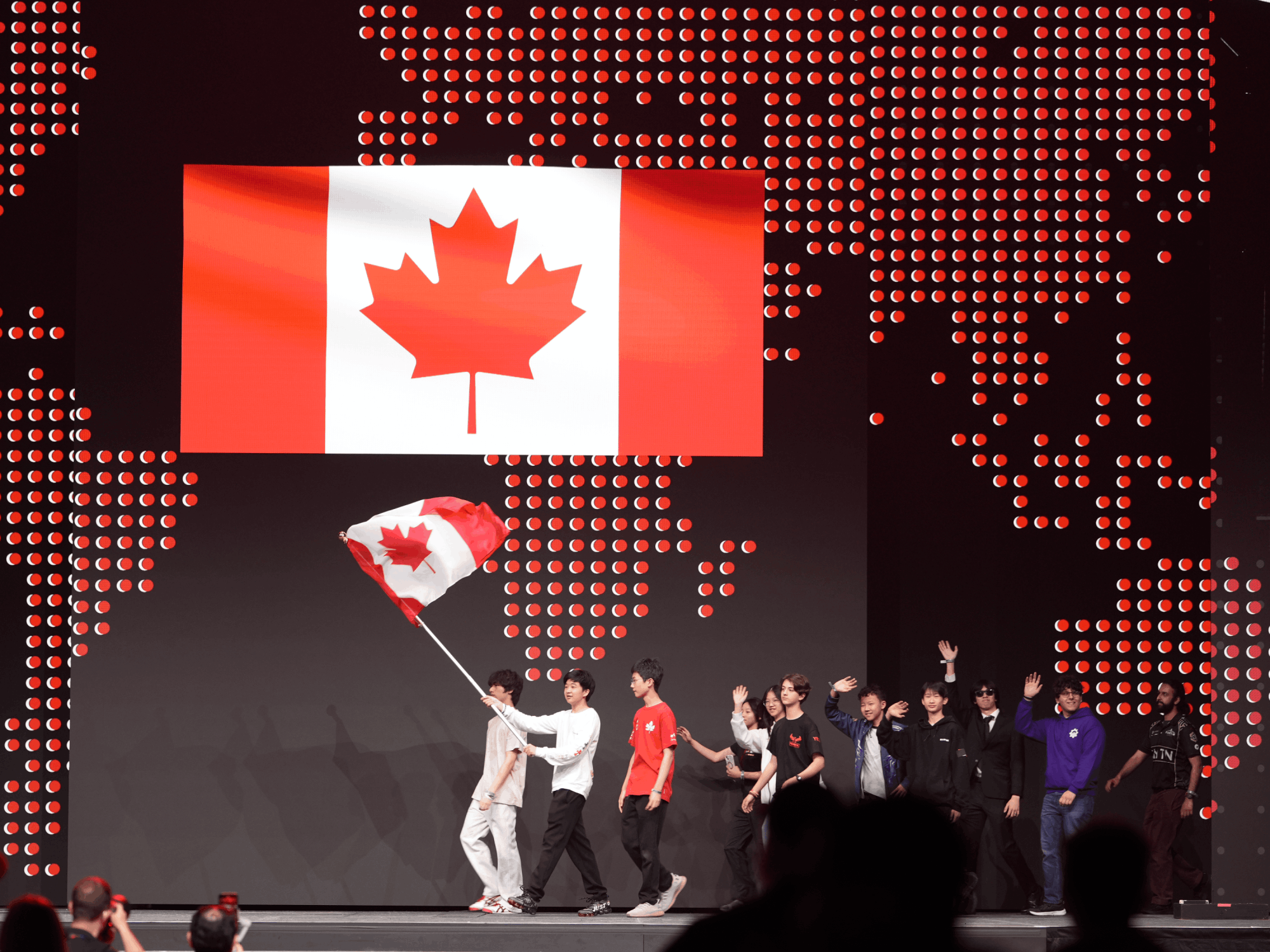 RoboPlanet student carrying Canada's flag